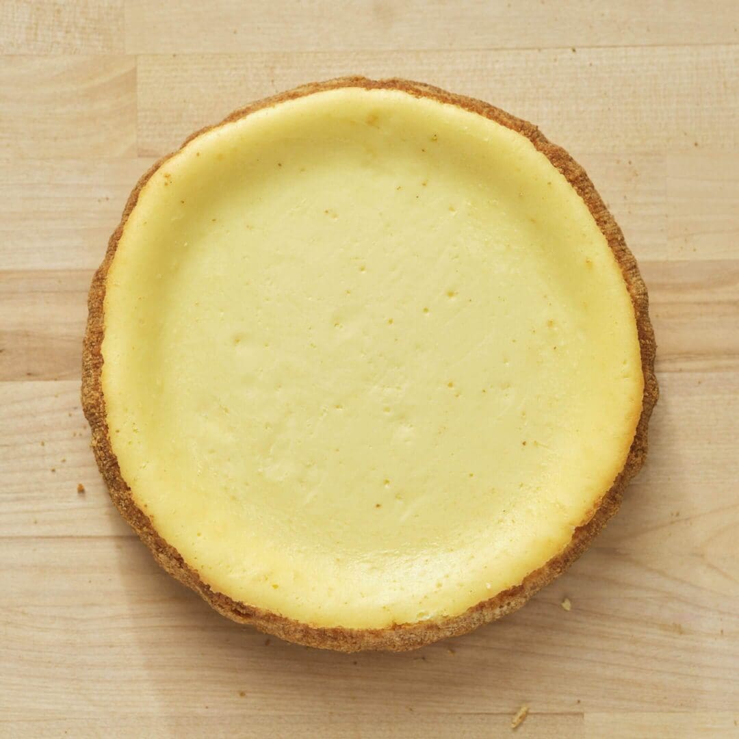 Cheesecake on wooden surface, top view.