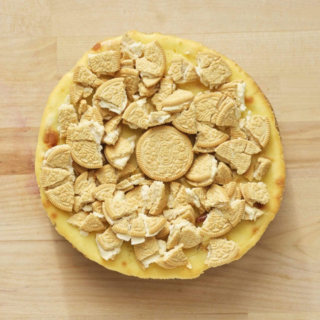 Cheesecake topped with crushed golden cookies.
