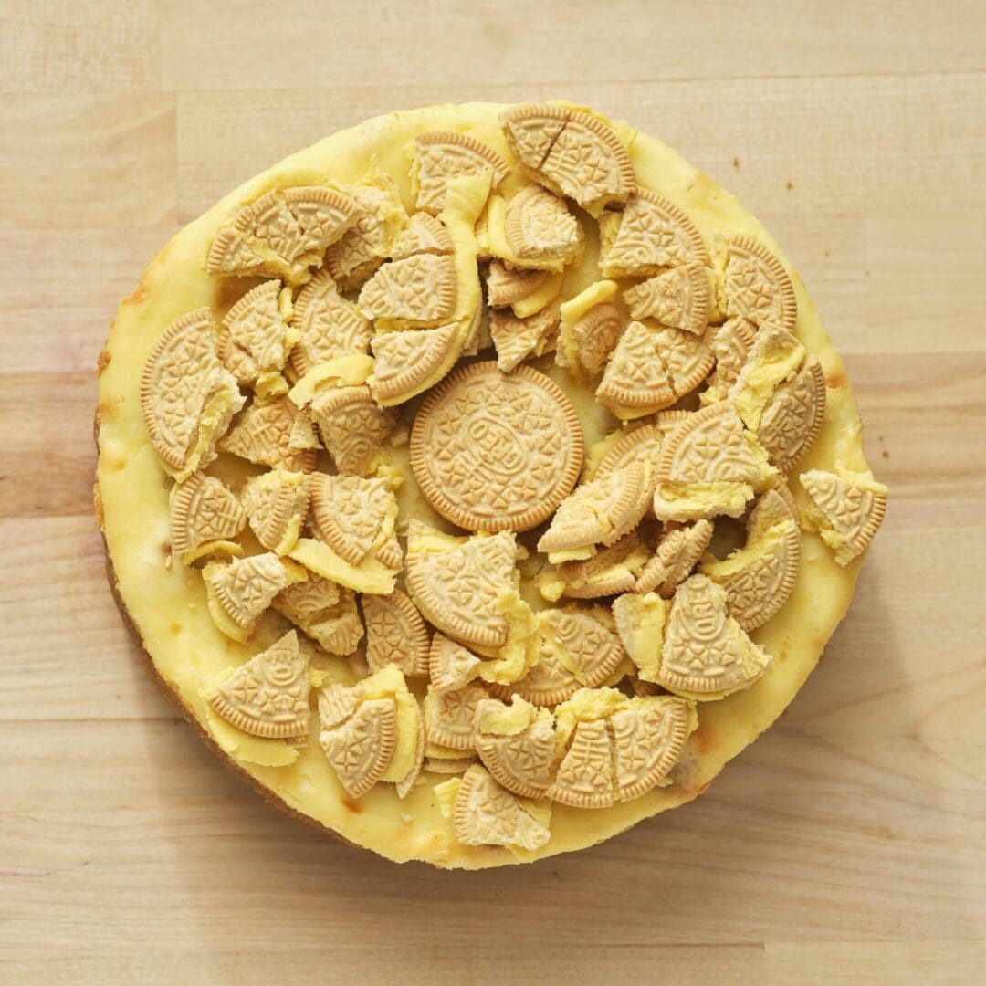 Cheesecake topped with crushed golden cookies.