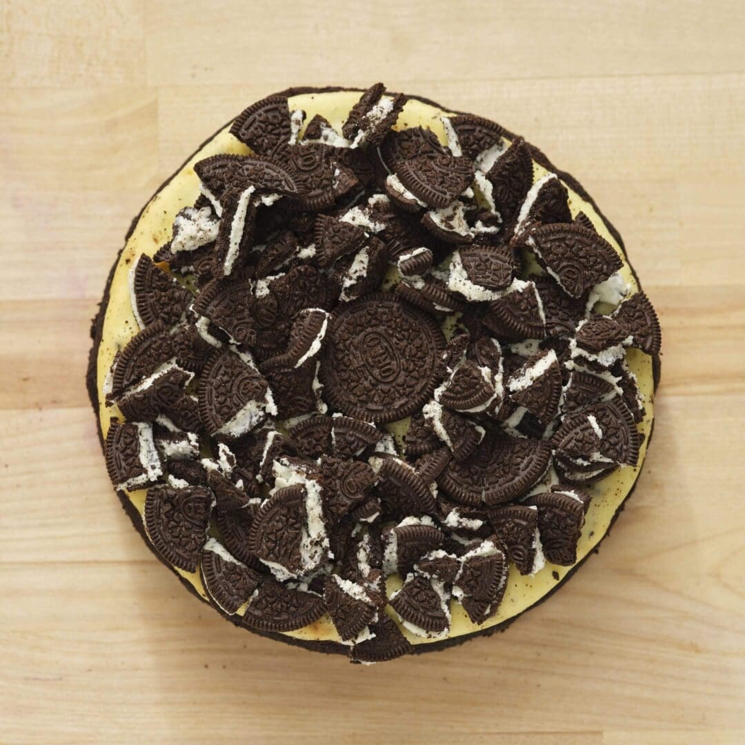 Cheesecake topped with crushed chocolate sandwich cookies.