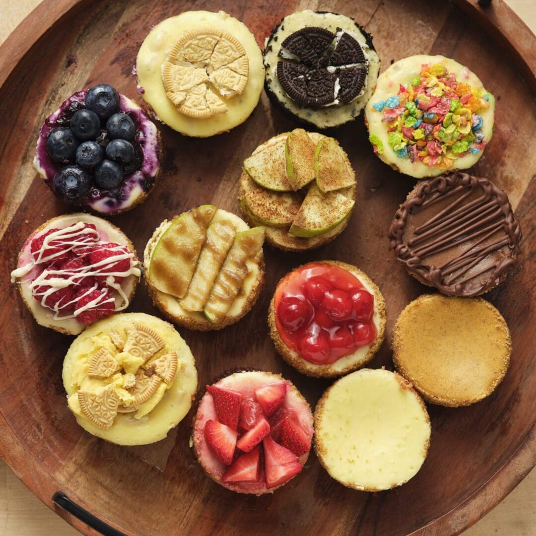 Assorted mini cheesecakes with various toppings.