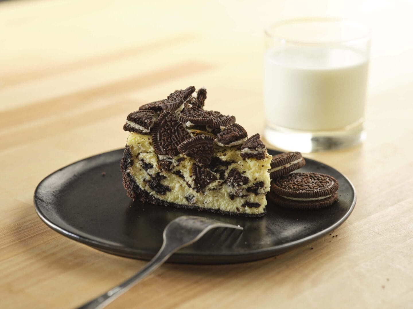 Cake slice with cookies and milk.