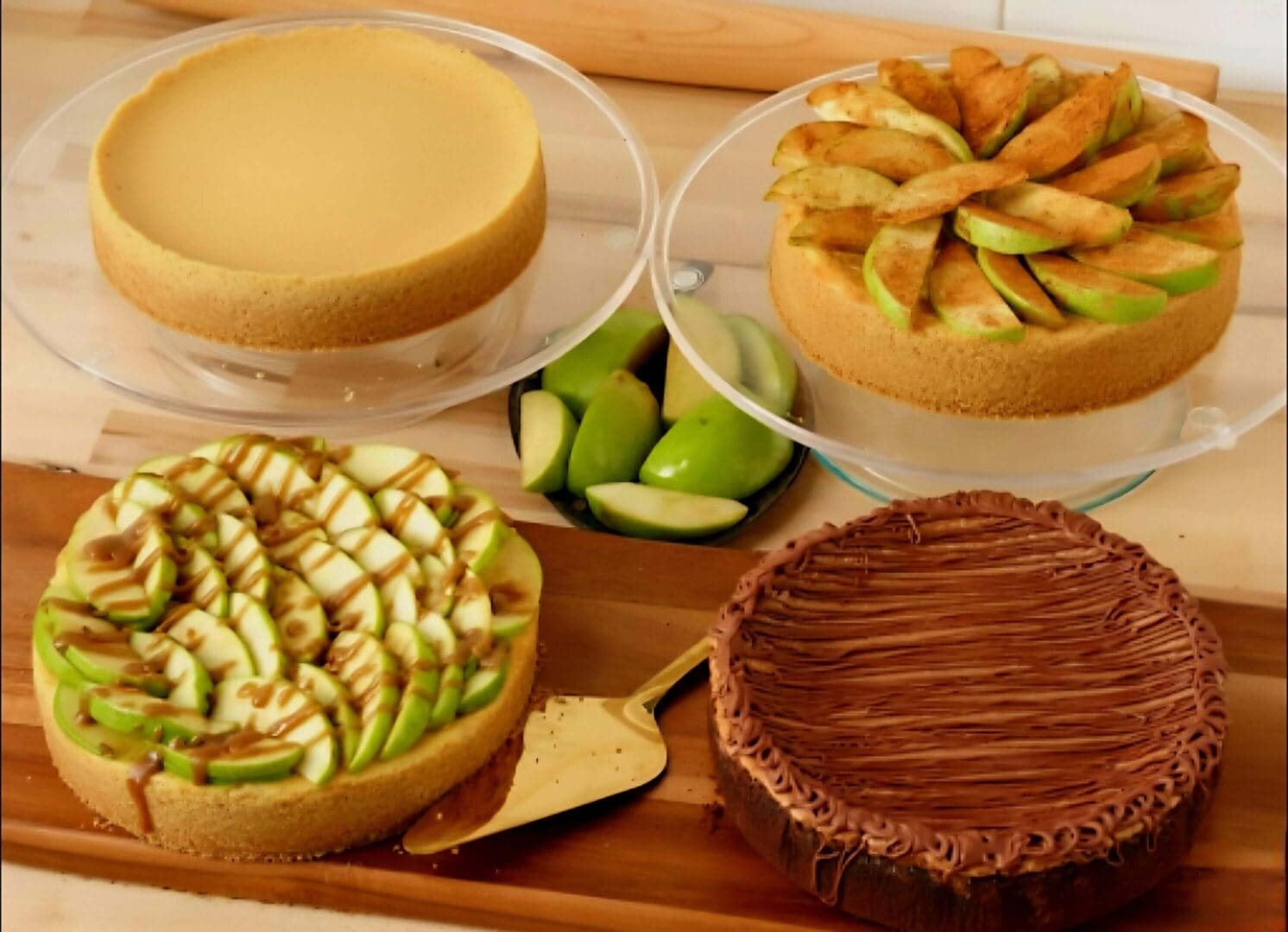 Assorted cakes with apples and caramel topping.