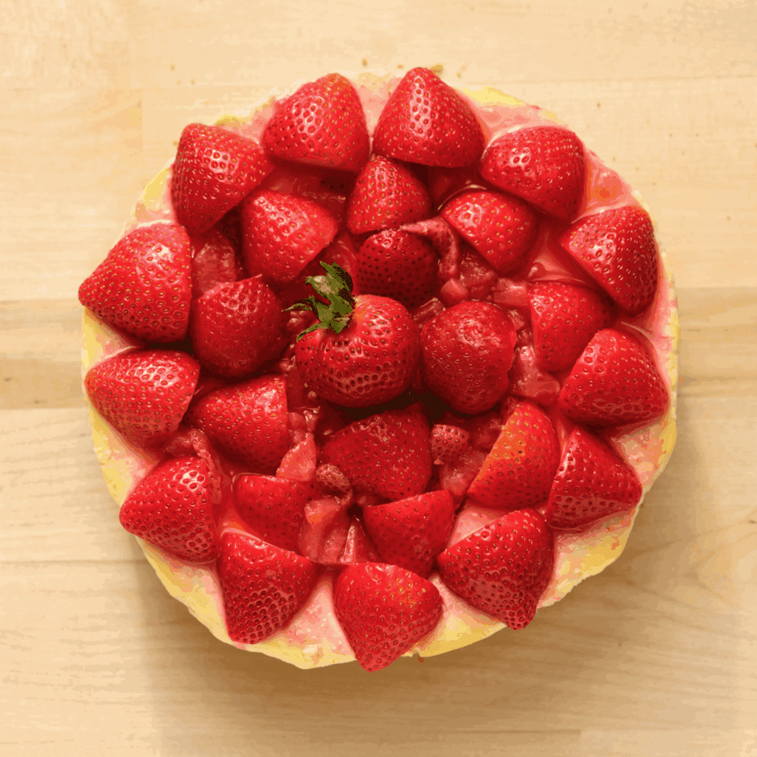 Strawberry tart on a wooden surface.