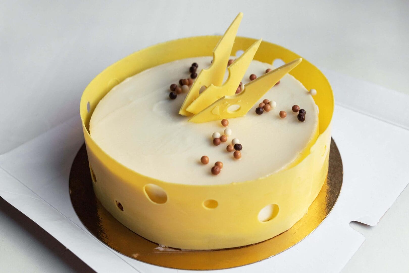 Yellow cake with chocolate decorations on top.