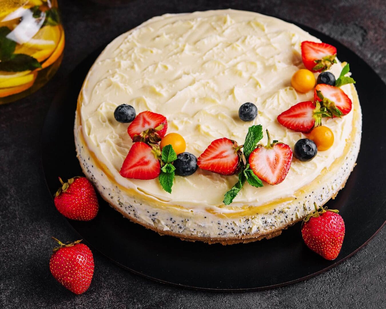 Cheesecake topped with berries and mint leaves.